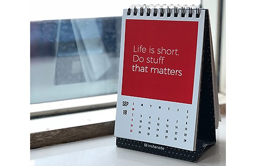 A calendar standing by a window